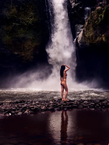 Photo of a Woman Wearing Bikini in Front of Waterfalls