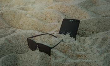 Photo of Phone and Sunglasses on Sand