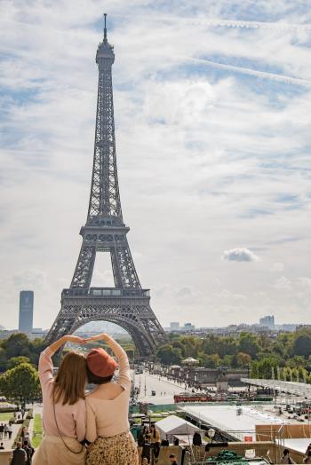 Photo of Two Women Posing in Front of Eiffel Tower, Paris, France during Day Time