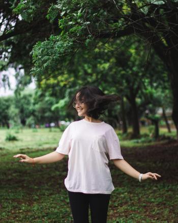 Photography of a Smiling Woman Near Trees