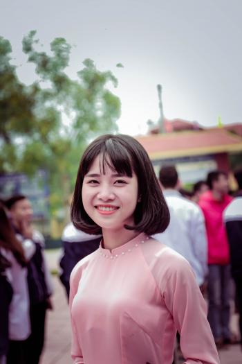 Photography of a Woman in Pink Long-sleeved Top Smiling