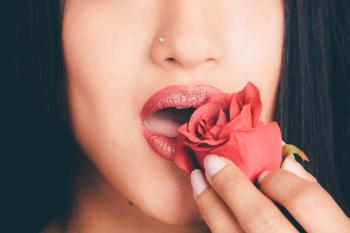 Photography of Woman Holding Red Rose