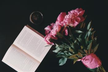 Pink Flower Bouquet Beside Opened Book