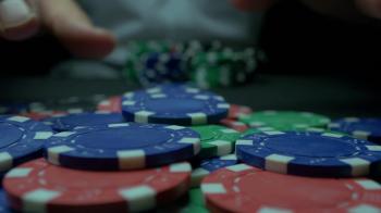 Poker chips and hands above it on green table. blackjack in a casino ...