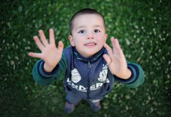 Portrait of Smiling Boy With Arms Outstretched