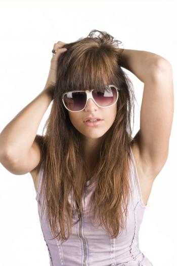 Portrait of Woman Wearing Sunglasses Standing Against White Background