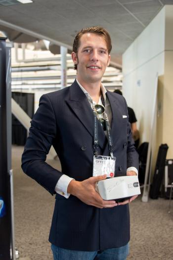 Posed portrait of Ed Mason (GameFace Labs CEO) holding GameFace prototype at SVVR expo