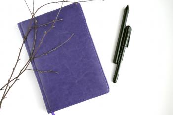 Purple Leather Notebook, Black Pen, and Brown Branches