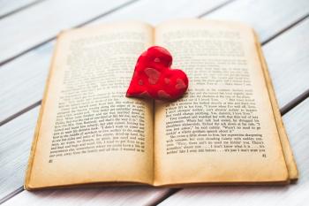 Red heart on a old opened book II