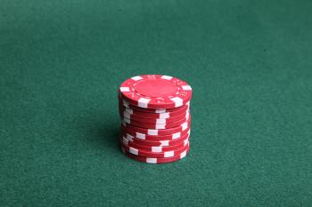 Red poker chips on green felt.