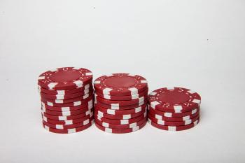 Red poker chips on white background