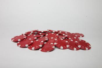Red poker chips on white background