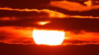 Beautiful scenic sunset sun moving across fiery red sky background ...