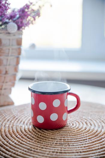 Red, White, and Black Ceramic Mug on Table