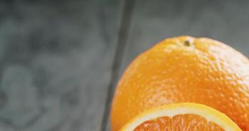 three ripe oranges on wooden table one half cut Stock Video Footage ...