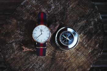 Round Silver-colored Analog Watch Beside Compass