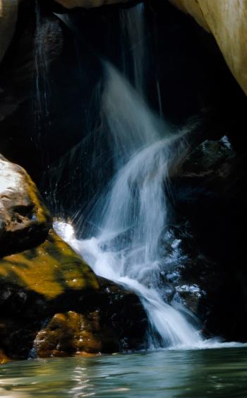 Photo of Running Water Between Brown Rocks · Free Stock Photo