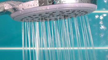 Shower head with running water in close up. Bathroom detail. Stock ...