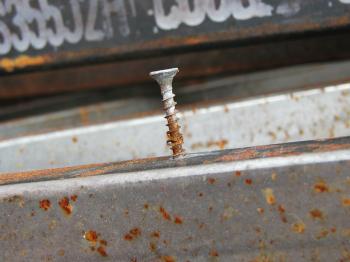Rusted screw in rusted metal