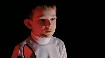 boy watching cartoons, sometimes kid looking scared. Low-key ...