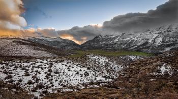 Scenic Photography of Mountains Covered With Snow Under Cloudy Sky