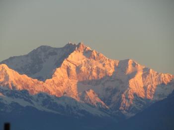 Scenic View of Snowcapped Mountains Against Sky at Sunset