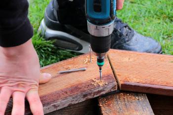 Screwing Wooden Board with a Drill