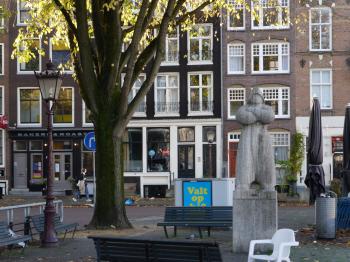 sculpture in the street with a autumn tree, in the city Amsterdam, Netherlands.