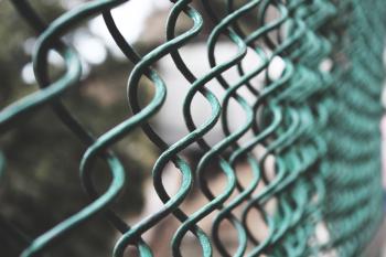 Selective Focus Photography of a Green Link Fence