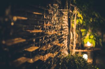 Selective Focus Photography of Brown Brick Wall during Nighttime