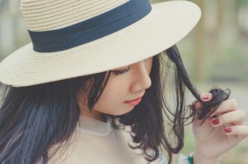 Selective Focus Photography of Woman With Brown Sun Hat