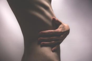 Side View Photo of Person Touching Stomach