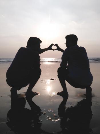 Silhouette of 2 Man Making Heart Sign