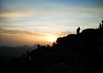 Silhouette of Group of Person Hiking on the Mountain