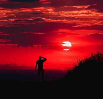 Silhouette of Man during Red Sun