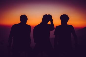Silhouette of Men Standing on Open Area Golden Hour Photography