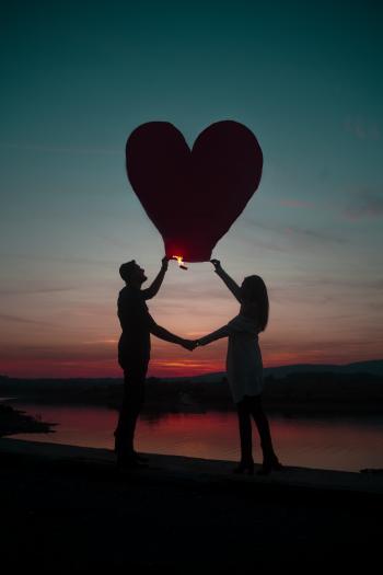 Silhouette Photo Of Man And Woman Holding Heart Lantern