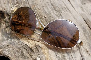 Silver Aviator Sunglasses on Top of Wooden Surface