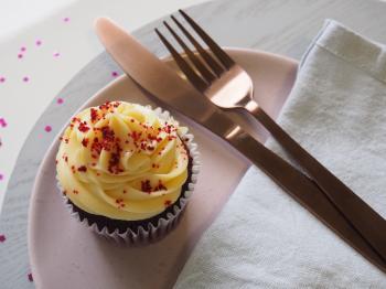 Silver Fork and Knife on Round Plate With Cupcake