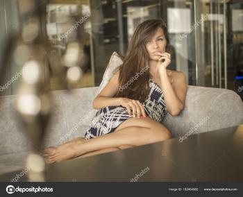 Above view pretty woman in short dress sitting on terrace in ...