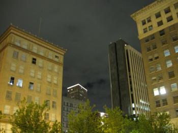 Skyscrapers against cloudy sky at night 2