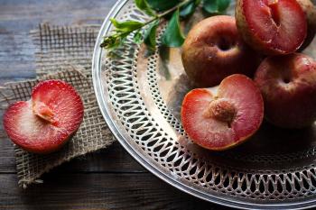 Sliced Plums on Silver Round Platter