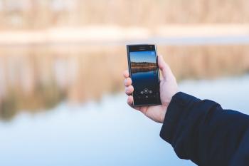 FreeUse - Man taking photo of a lake with mobile phone high quality ...