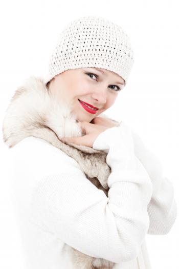 Smiling Woman Wearing White Knit Cap and White and Beige Fur Lined Coat