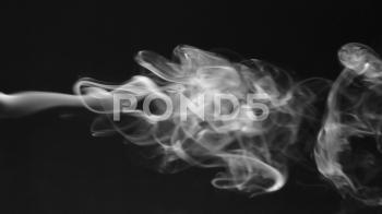 Stream of white smoke turning into smoke puffs on a black background ...