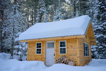 Snow Covered Wooden House Inside Forest