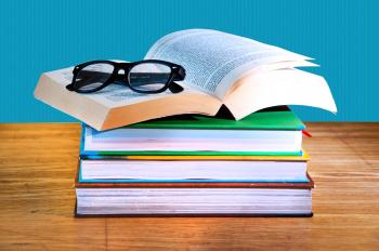 Stack of books with a pair of eyeglasses