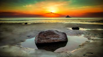 Stone Beside Seashore at Sunset