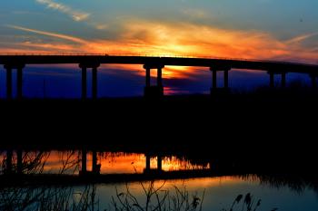 Sunset behind bridge