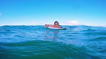 Attractive Surf Girl In The Ocean Floating Holding Surfboard In The ...